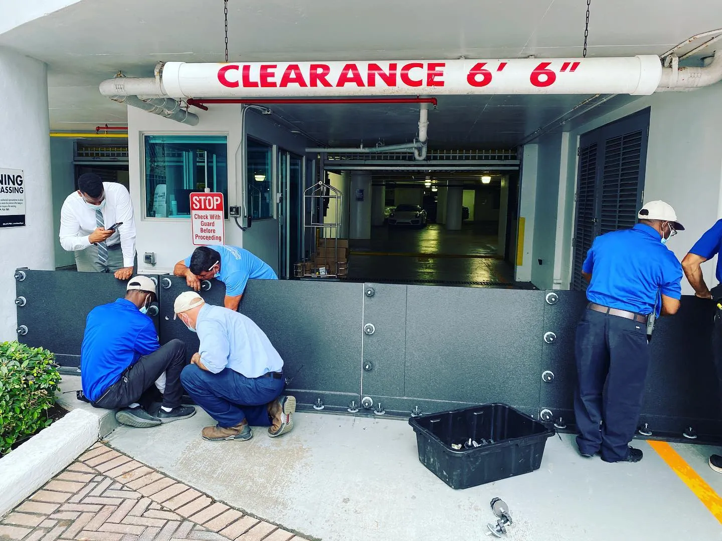 FRA crew installing flood panels at a parking garage entrance